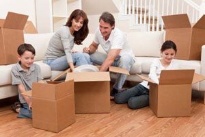 Family unpacking moving boxes