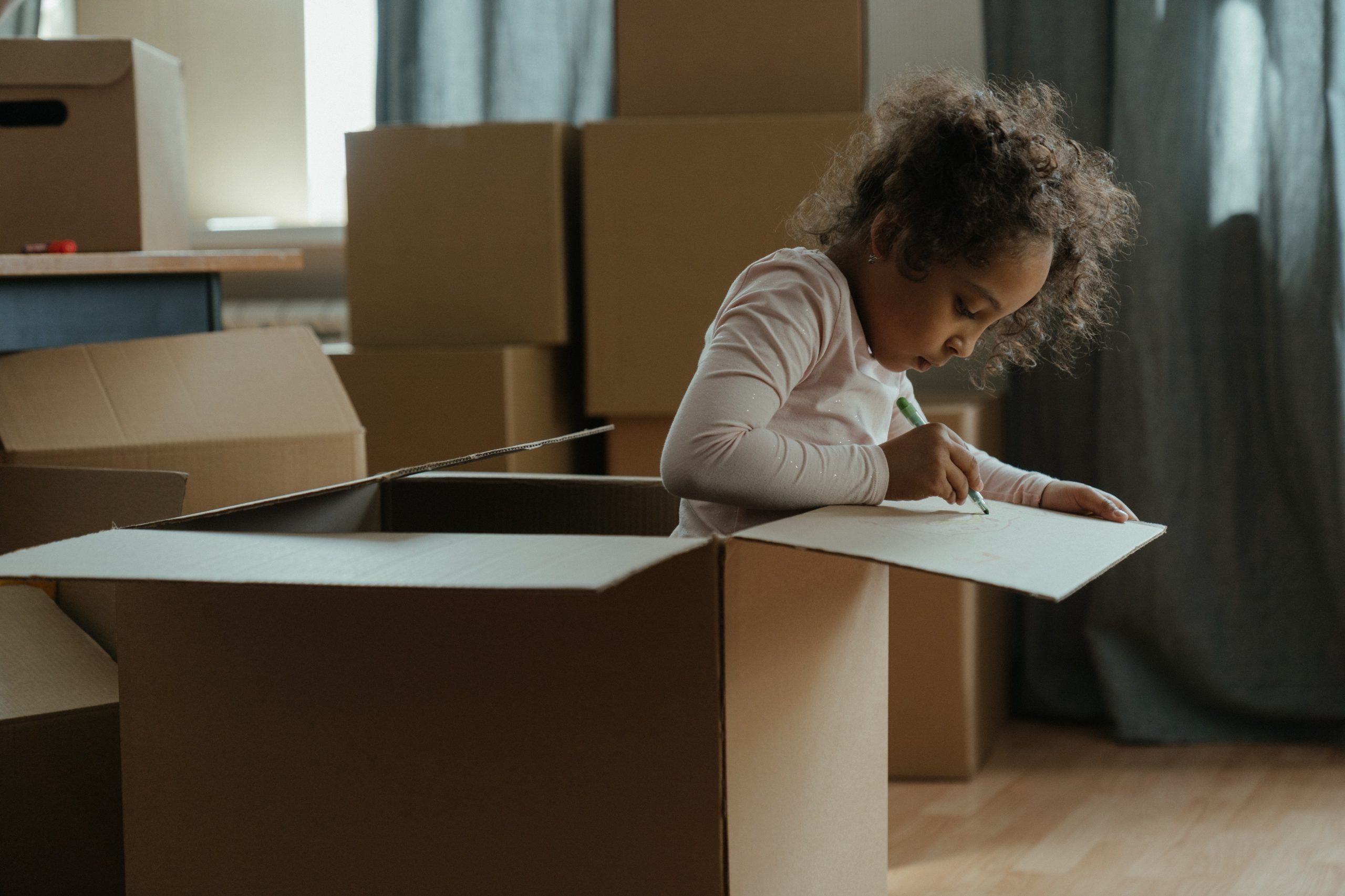 child in moving box